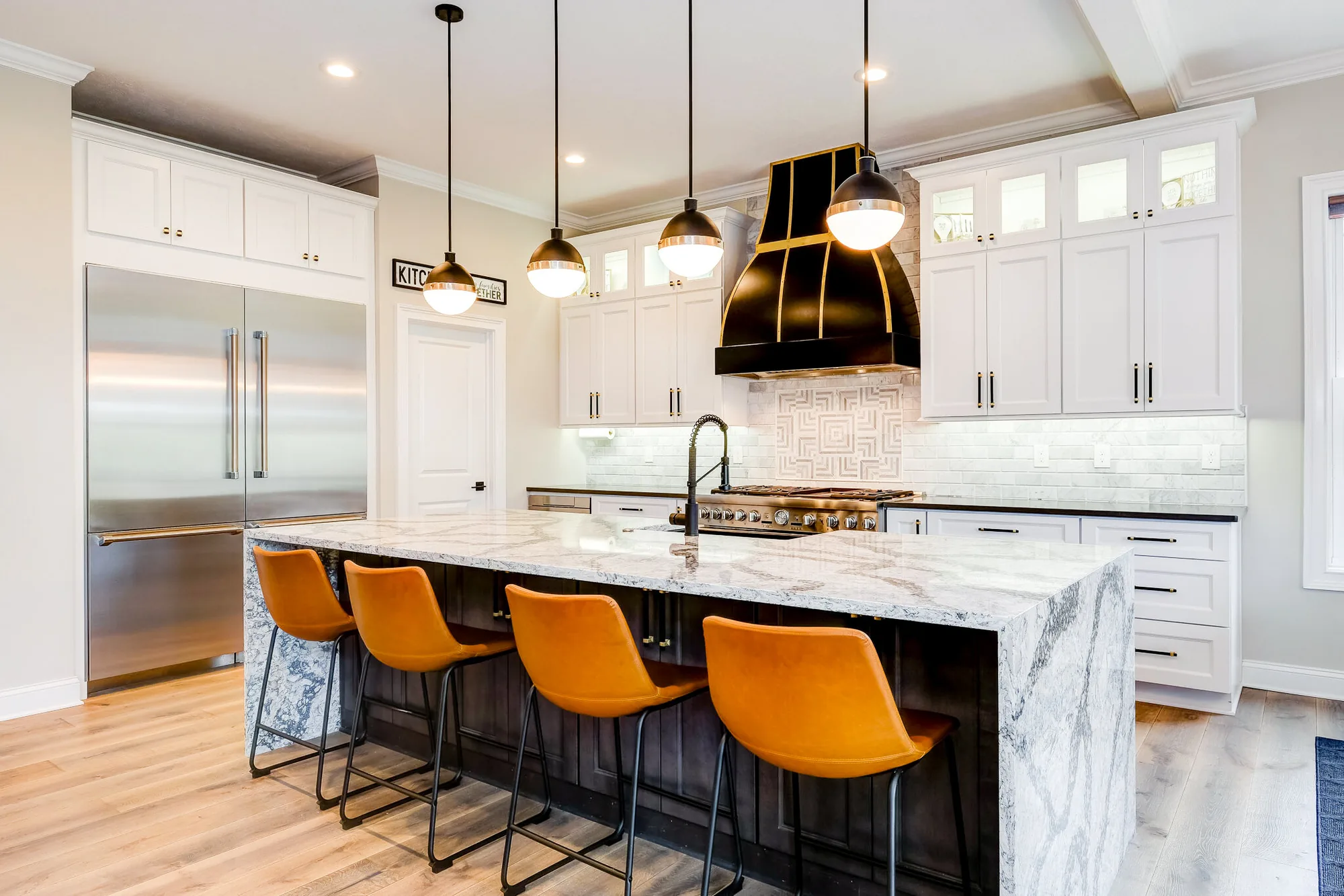 Kitchen completed by BKG Design in Cranberry Twp, PA, with a marble island and a black and brass hood